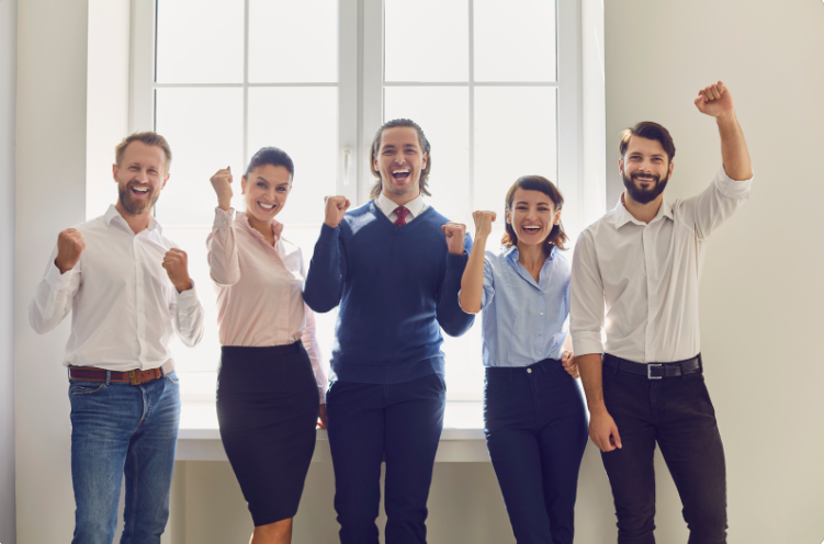 A group of smiling professionals feeling relief from stress, anxiety, and burnout.